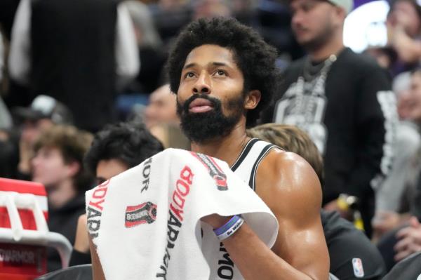 Nets guard Spencer Dinwiddie looks at the scoreboard as he sits on the bench