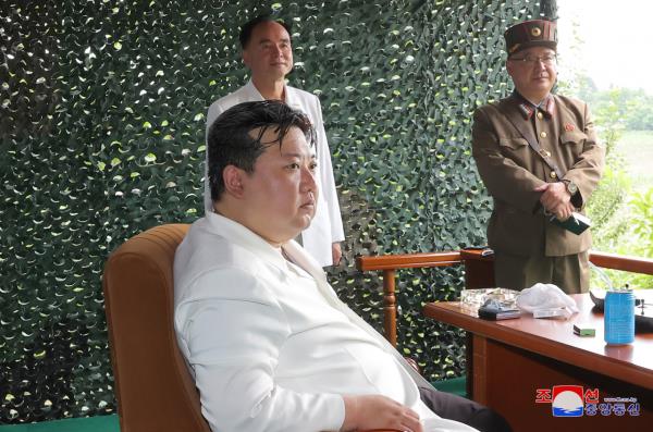 North Korean leader Kim Jong-un (front) inspects the launch of a Hwasong-18 solid-fuel interco<em></em>ntinental ballistic missile (ICBM) on Wednesday in this photo released by the North's official Korean Central News Agency. (Yonhap)